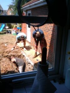 Builders working hard to deepen the trench