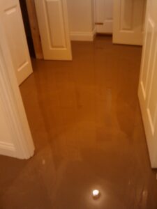 Latex screed poured onto floor. It is not actually latex, but they still call it that. More like a really runny plaster that sets like concrete.