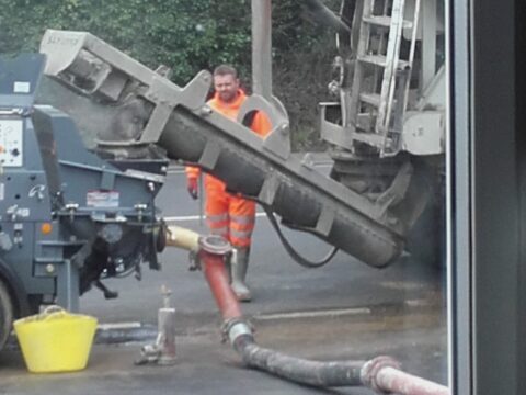 concrete lorry pouring into the pump