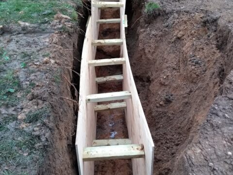 foundation trench with wood wall supports