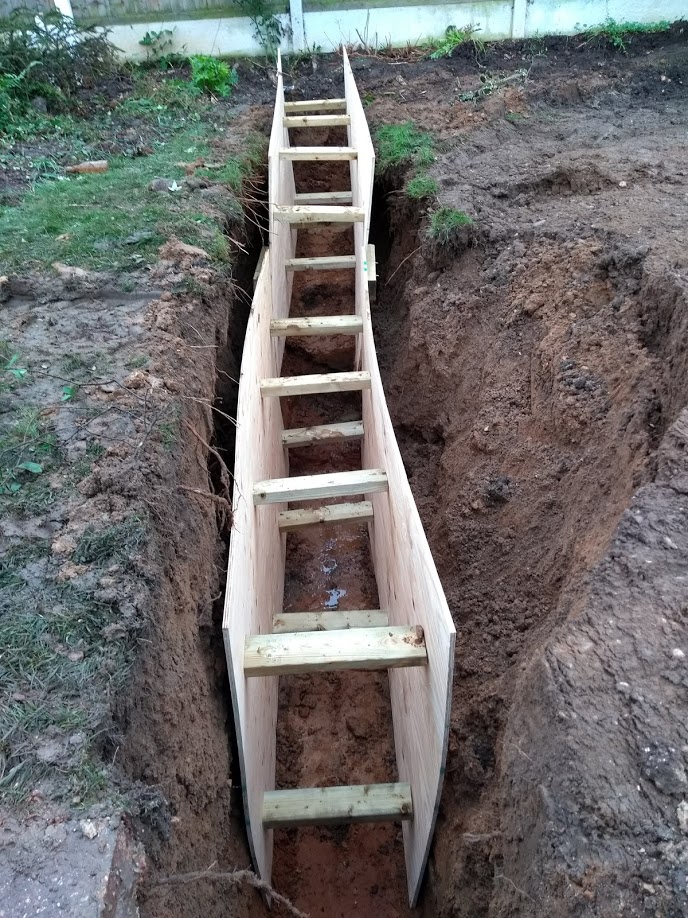 foundation trench with wood wall supports